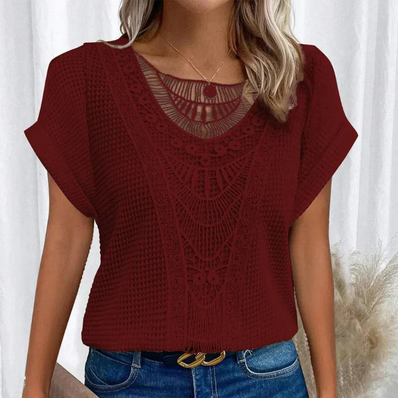 Textured crochet-style women's blouse, short sleeve, round neck. A stylish and breathable summer top.