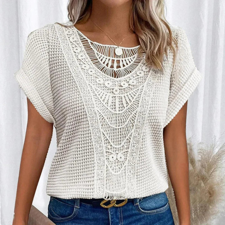 Women's decorative crochet-style short sleeve blouse, round neck. Elegant casual summer fashion.