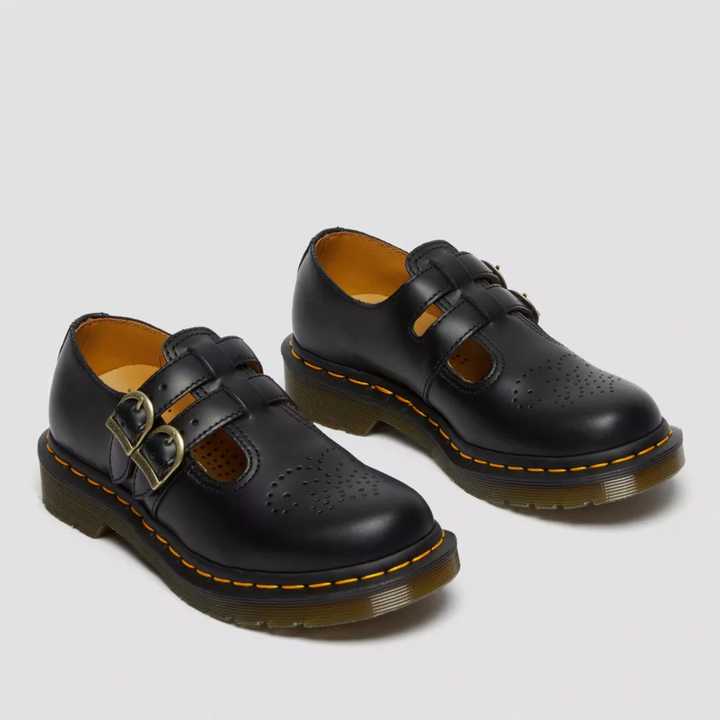 Close-up of double buckle detail on women's vintage style Mary Janes, black leather finish.