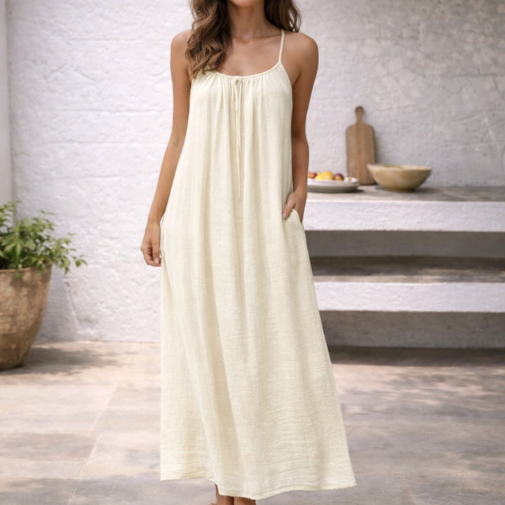 Women's spaghetti strap maxi dress with convenient pockets, a comfortable summer sundress for warm weather.