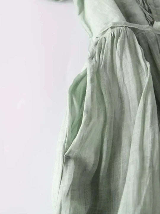 Woman in a comfortable flowy summer dress, showcasing its relaxed fit and effortless movement for warm days.