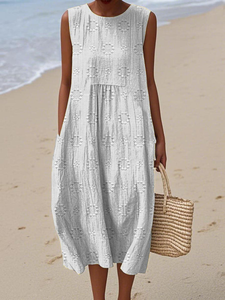 Front view of a women's relaxed fit midi dress with pockets, sleeveless, ideal as a casual summer dress.