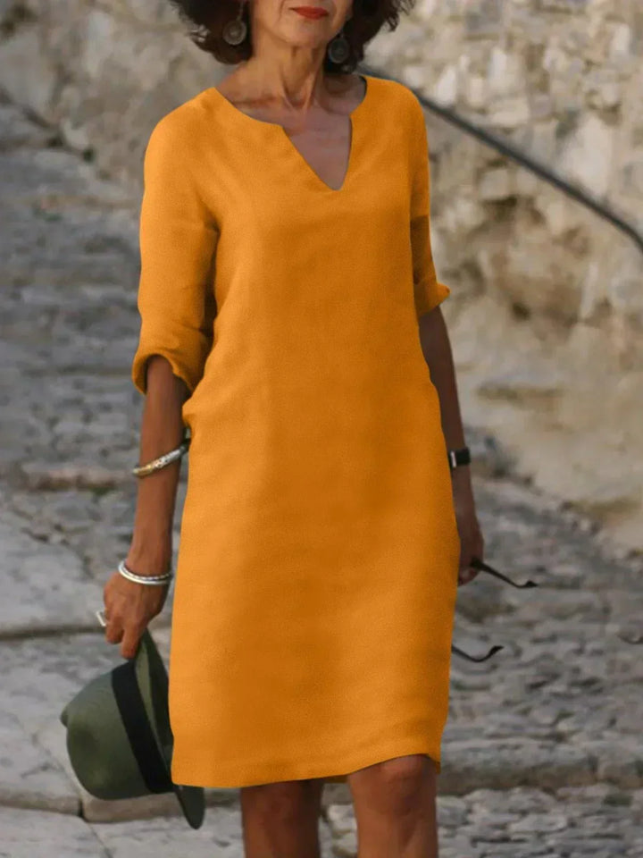 Versatile women's v-neck mini dress with 3/4 sleeves. Casual short dress for everyday comfort.
