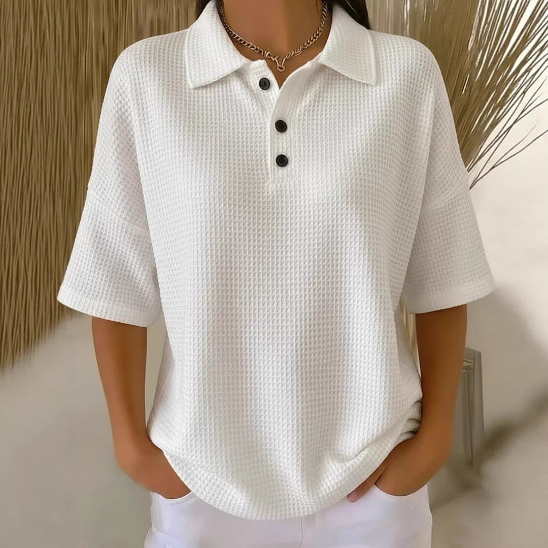 Comfortable women's waffle knit polo blouse with short sleeves and a relaxed fit, perfect for everyday.
