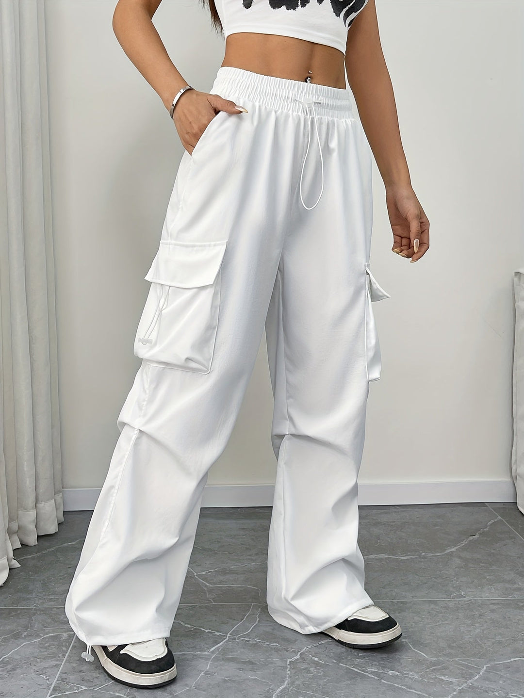 Women's effortless wide leg cargo pants with drawstring waist in a relaxed fit. Perfect for casual streetwear.