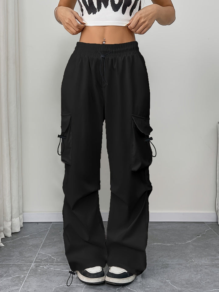 Comfortable women's wide leg cargo pants with drawstring waist & pockets. Ideal for travel & everyday wear.