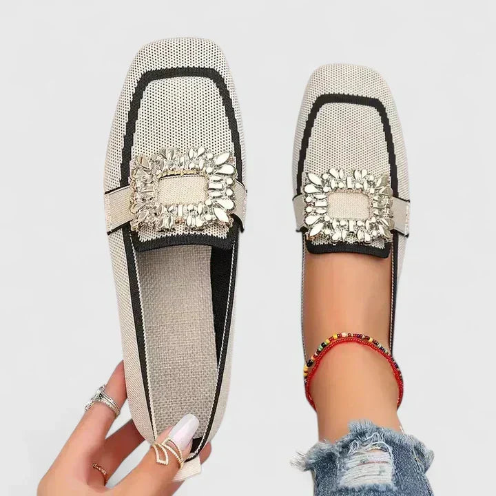 Women's elegant black square-toe flat loafers with a sparkling crystal buckle, perfect for stylish everyday wear.