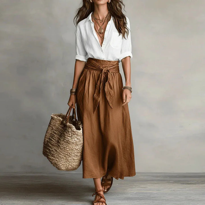 Breathable women's linen matching set; loose-fit blouse and elastic-waist skirt for comfortable summer styling.
