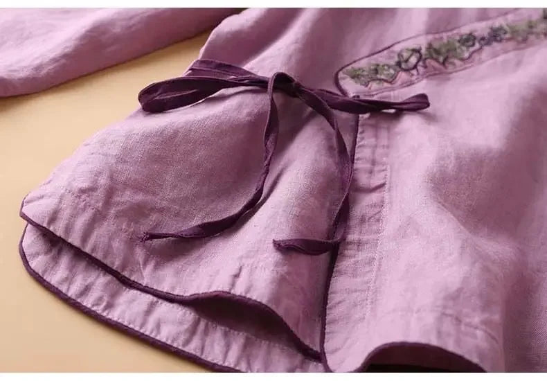 Relaxed fit women's patterned top, V-neck, elegant design. Comfortable & versatile blouse.