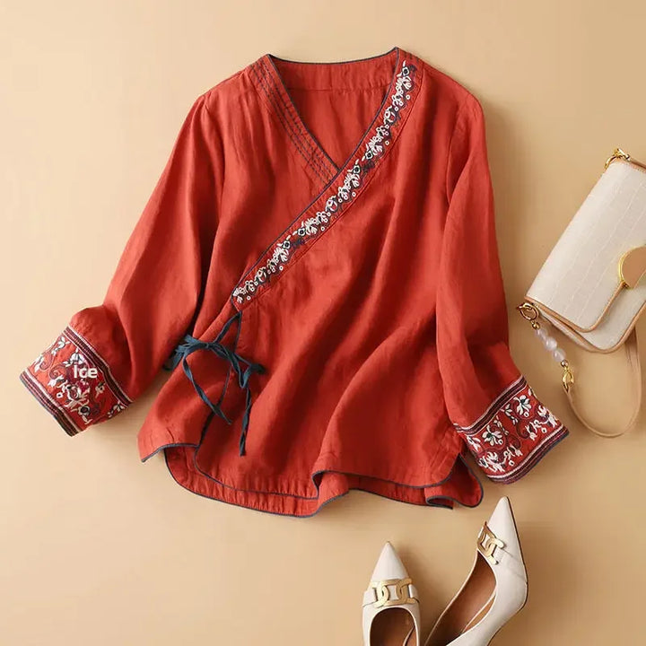 Stylish women's patterned top, V-neck, relaxed fit. Casual blouse with elegant embroidery.
