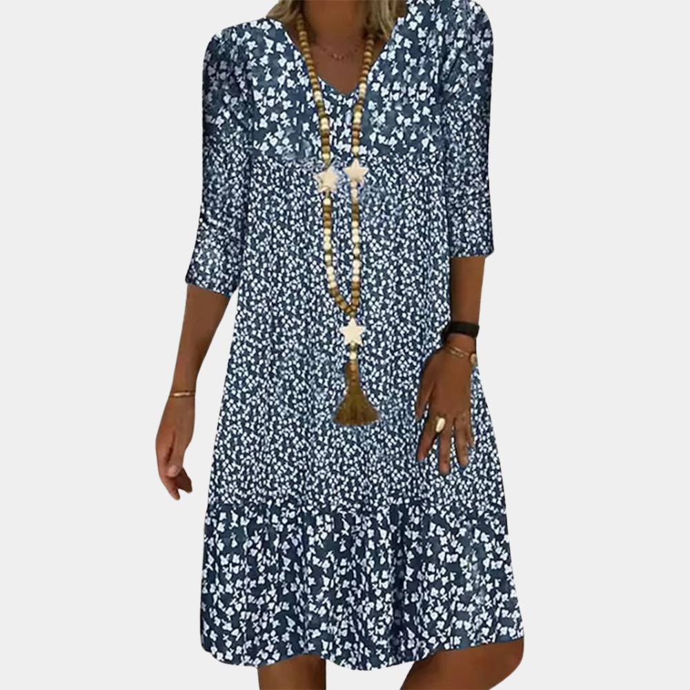 Airy spring/summer women's printed midi dress. A-line silhouette, V-neck, and 3/4 sleeves for effortless style.