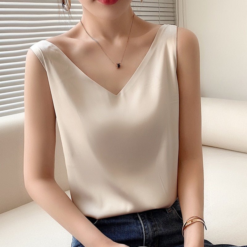 Fashionable women's silky tank top. Draped, sleeveless design with a polished sheen. Chic, versatile summer wear.