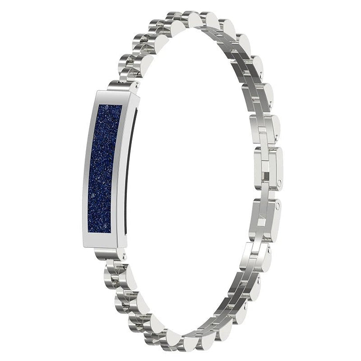 Woman wearing elegant smart bracelet on wrist, tracking activity, heart rate & receiving smart alerts.