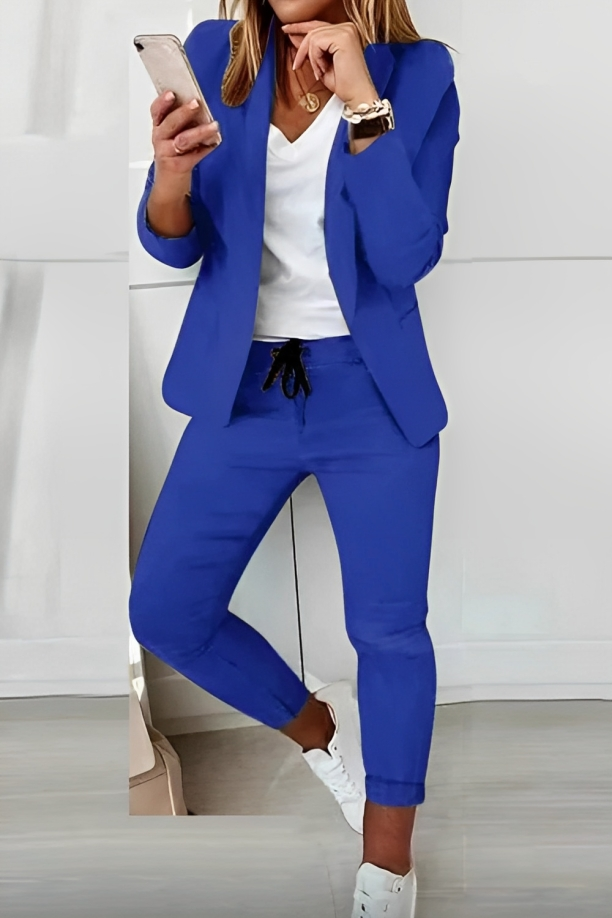 Tailored women's two-piece blazer & pants set, offering a sleek, professional look for office or an elegant evening out.