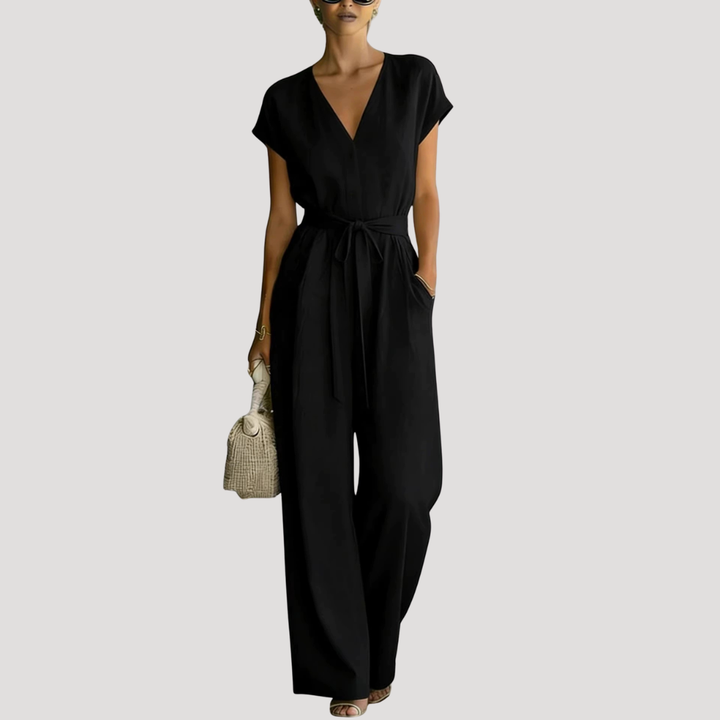 Stylish women's V-neck jumpsuit featuring a flattering tie waist and flowing wide legs for summer comfort.