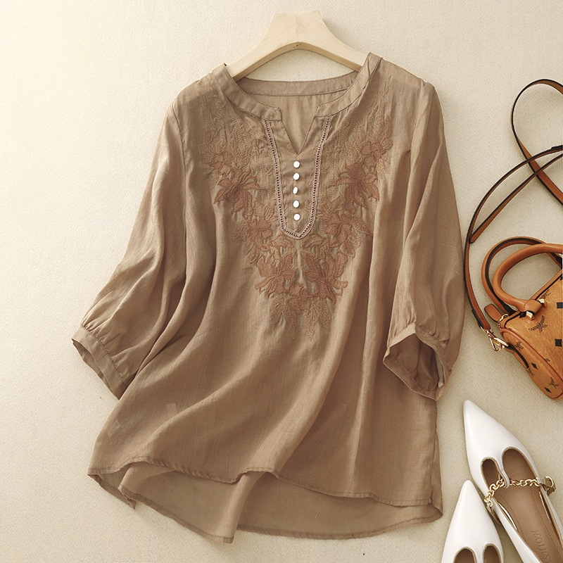 Stylish women's linen blouse featuring intricate floral embroidery, a comfortable and elegant summer shirt