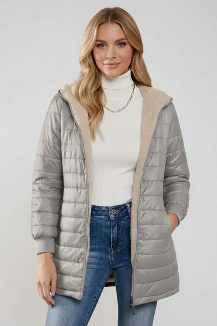 Close-up of women's hooded zip jacket fabric and zipper. Everyday comfort and quality details.