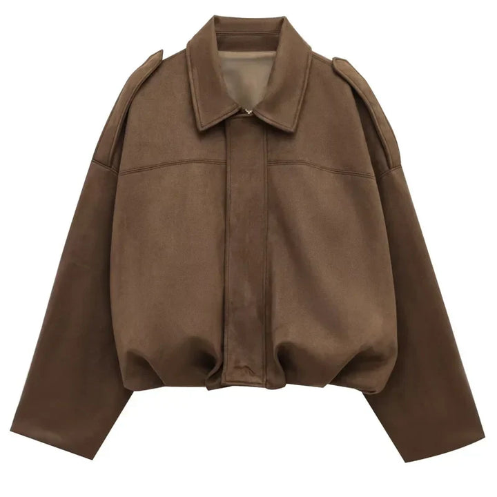 Full-body shot of a model wearing a women's faux suede bomber jacket with a minimalist outfit