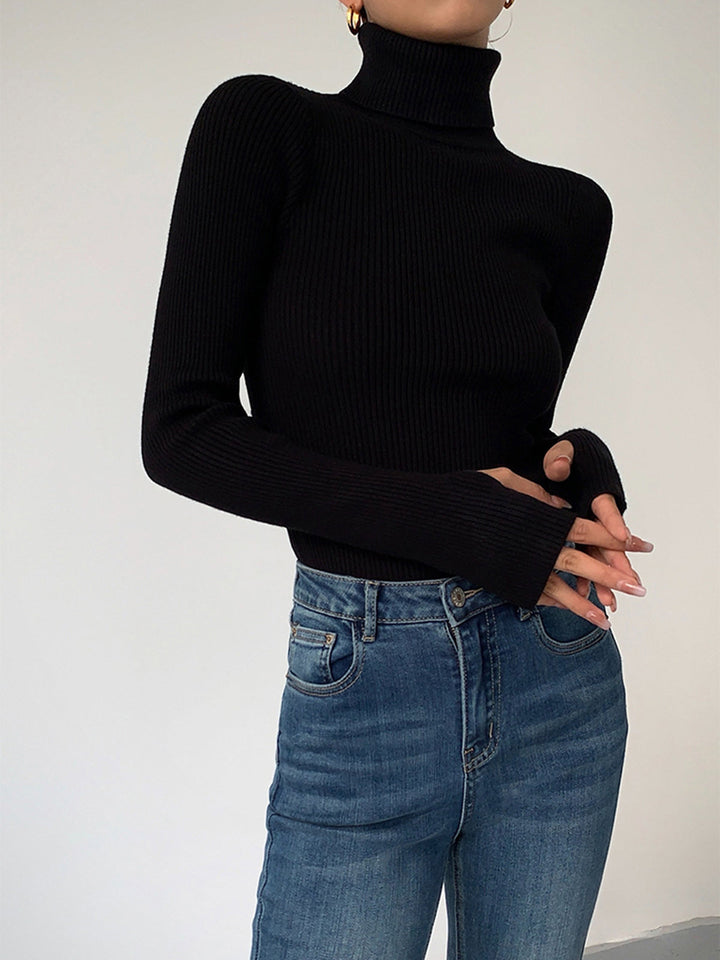 Detail of the turtleneck collar on a women's ribbed knit sweater, offering warmth and style for spring.