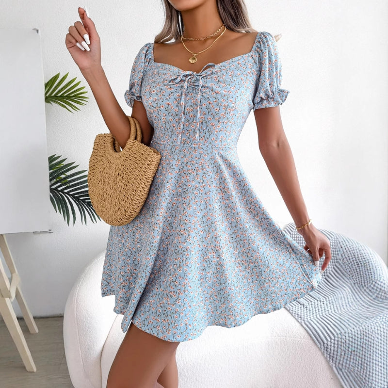 Full shot of a model wearing a women's floral A-line summer midi dress, casual style