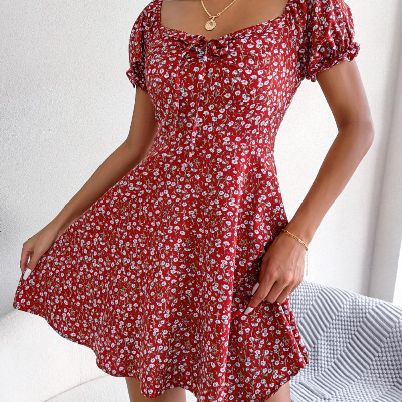 View of the A-line silhouette of a women's summer floral midi dress with ruffles
