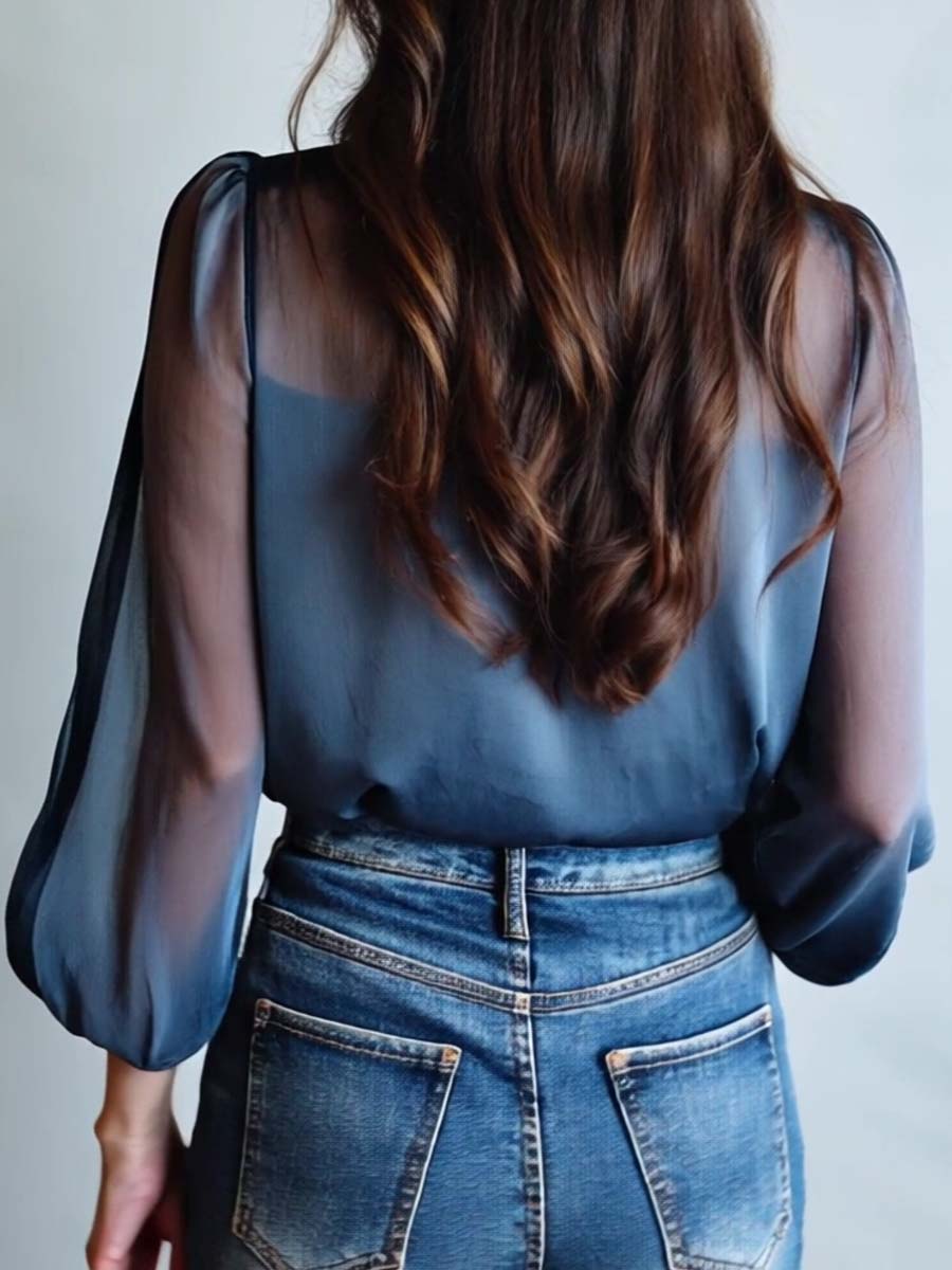 Women's v-neck blouse featuring vibrant floral embroidery and fashionable sheer sleeves.