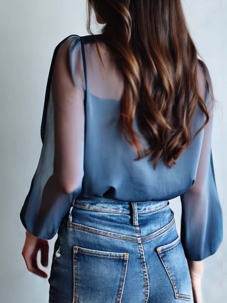 Casual chic women's floral embroidered blouse featuring sheer sleeves & a v-neck.
