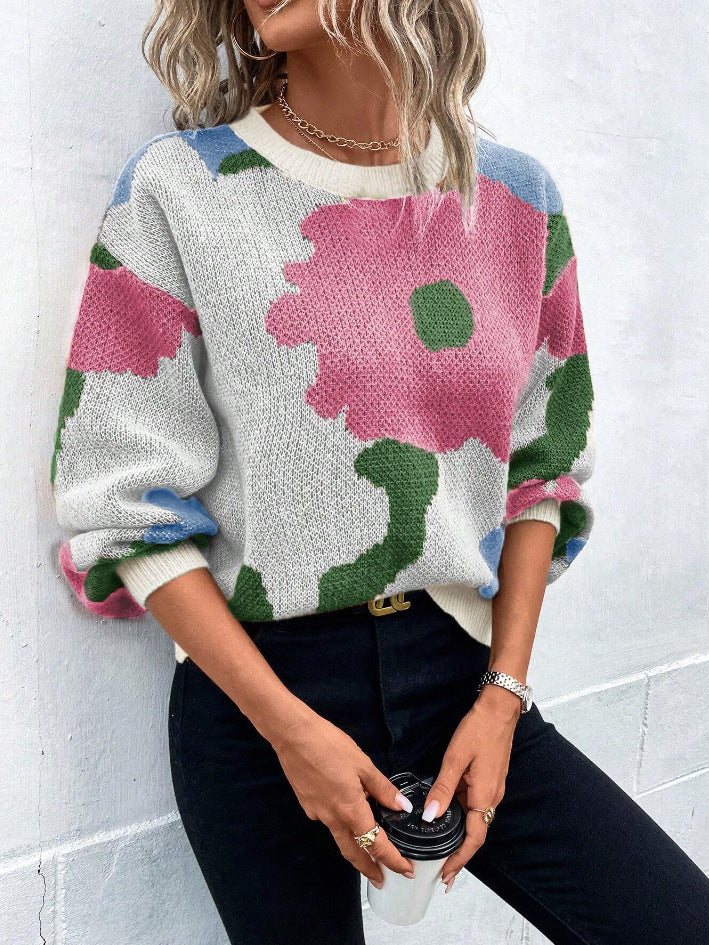 Close-up of a women's floral print long sleeve sweater, showcasing the fabric and design.