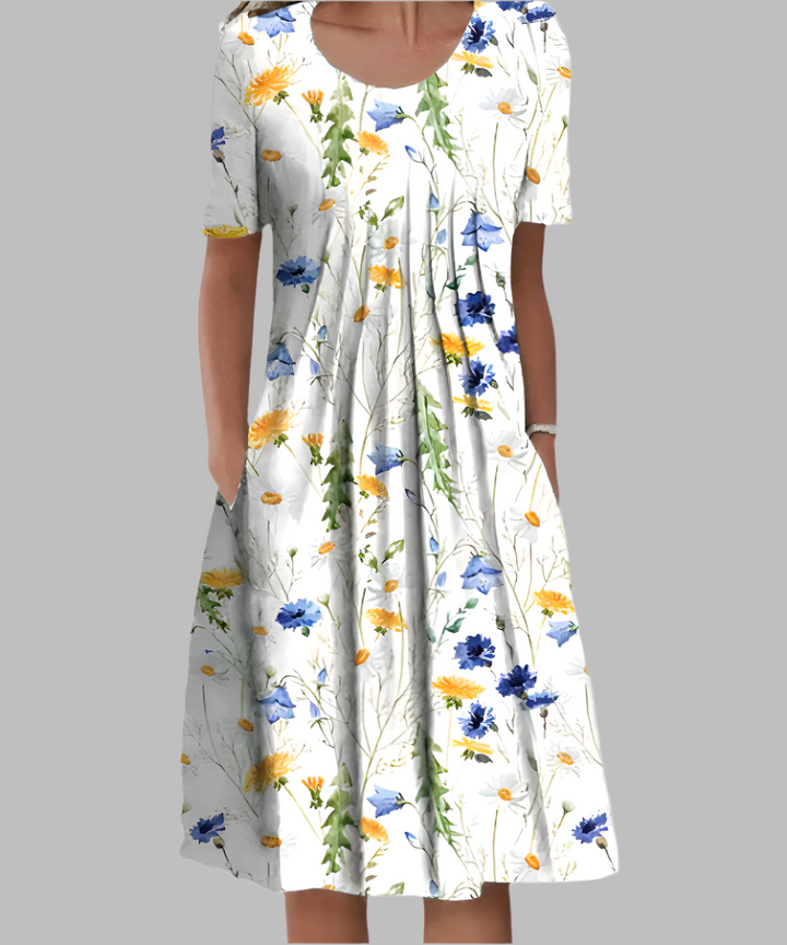 Stylish women's floral midi dress, perfect for summer. Features short sleeves, a comfortable fit, and practical pockets.