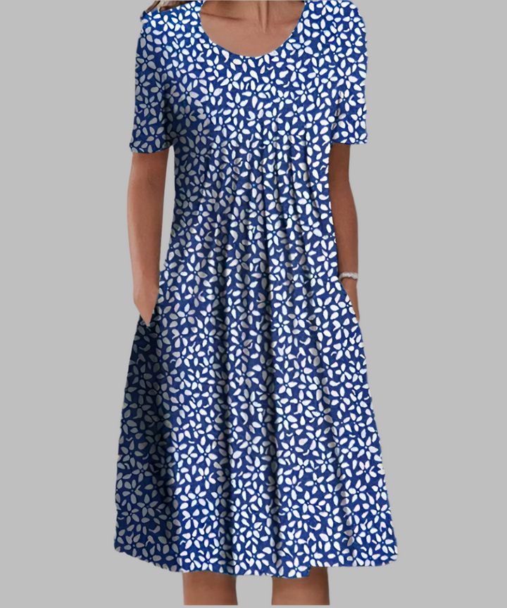 Vibrant floral print midi dress for women. Features short sleeves, practical pockets, and a flattering midi length.