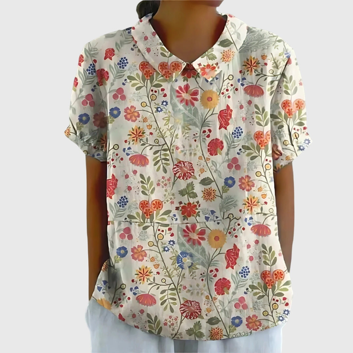 Vibrant floral print women's short sleeve blouse, collared and comfortable for spring/summer fashion.
