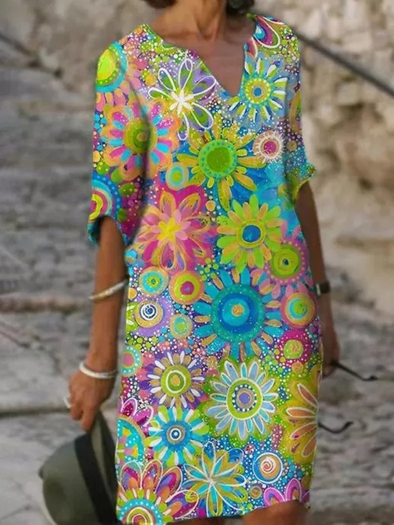Vibrant yellow floral print V-neck summer dress, A-line bohemian style, ideal for vacation or day wear.
