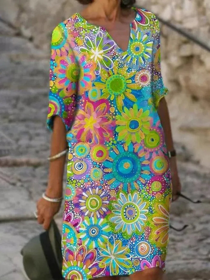 Vibrant yellow floral print V-neck summer dress, A-line bohemian style, ideal for vacation or day wear.