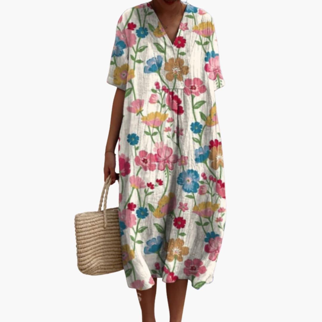 Women's floral V-neck midi dress with short sleeves. Oversized, comfortable fit for summer casual wear.