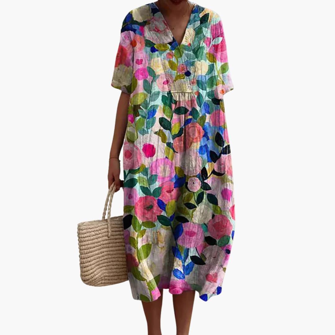 Casual oversized women's midi dress with a vibrant floral print, V-neck, and comfortable short sleeves.