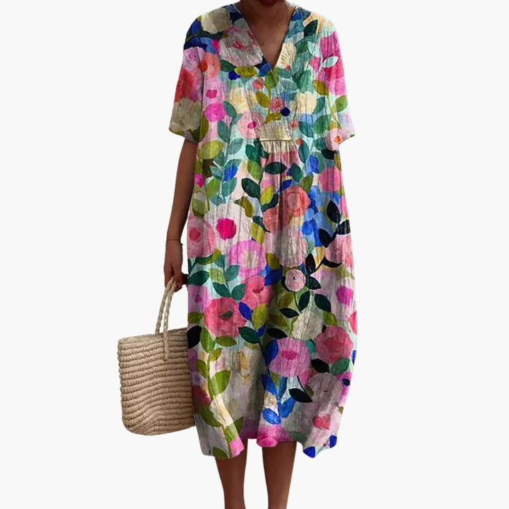 Casual oversized women's midi dress with a vibrant floral print, V-neck, and comfortable short sleeves.