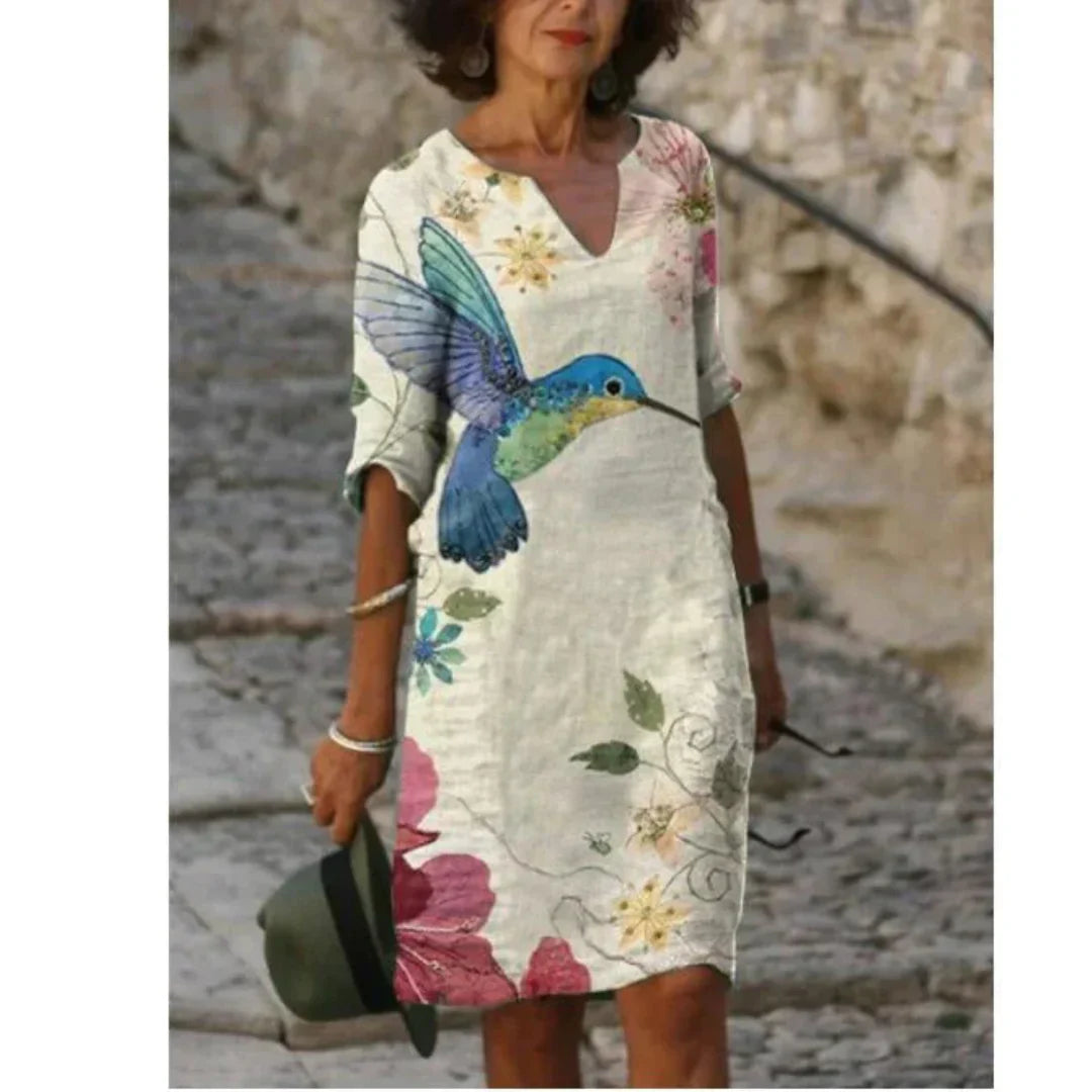 Side view of a woman wearing a floral V-neck midi dress, showcasing its elegant silhouette.
