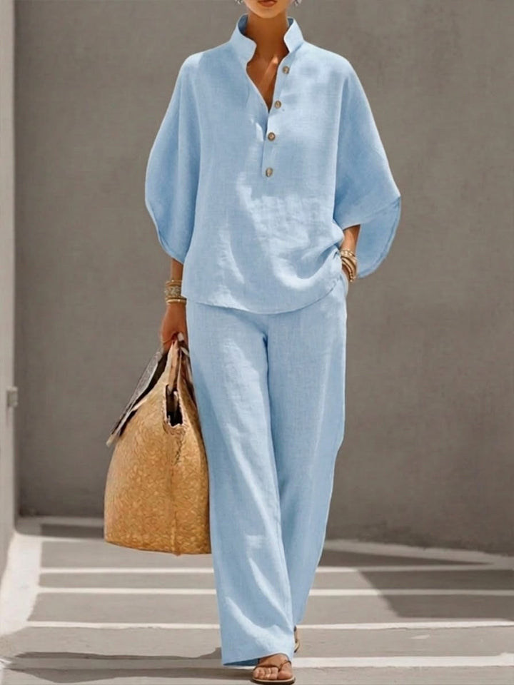 Elegant women's two-piece set featuring a batwing sleeve blouse and wide leg pants. Effortless fashion.