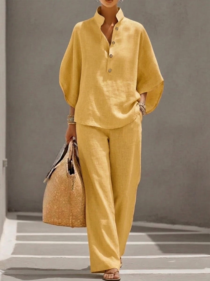 Coordinating women's outfit: batwing sleeve blouse & wide leg pants. Perfect for effortless style.