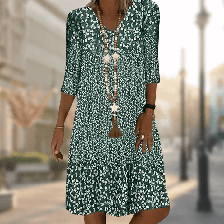 Vibrant floral print tiered summer dress for women, featuring a flowy silhouette, V-neck, and 3/4 sleeves.