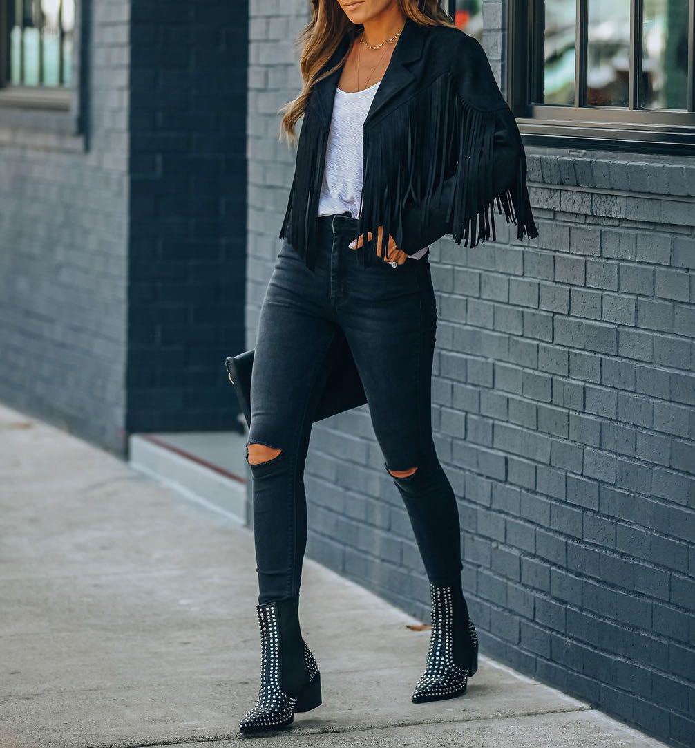Back view of a women's tan suede fringe jacket, showcasing bohemian style and outerwear design