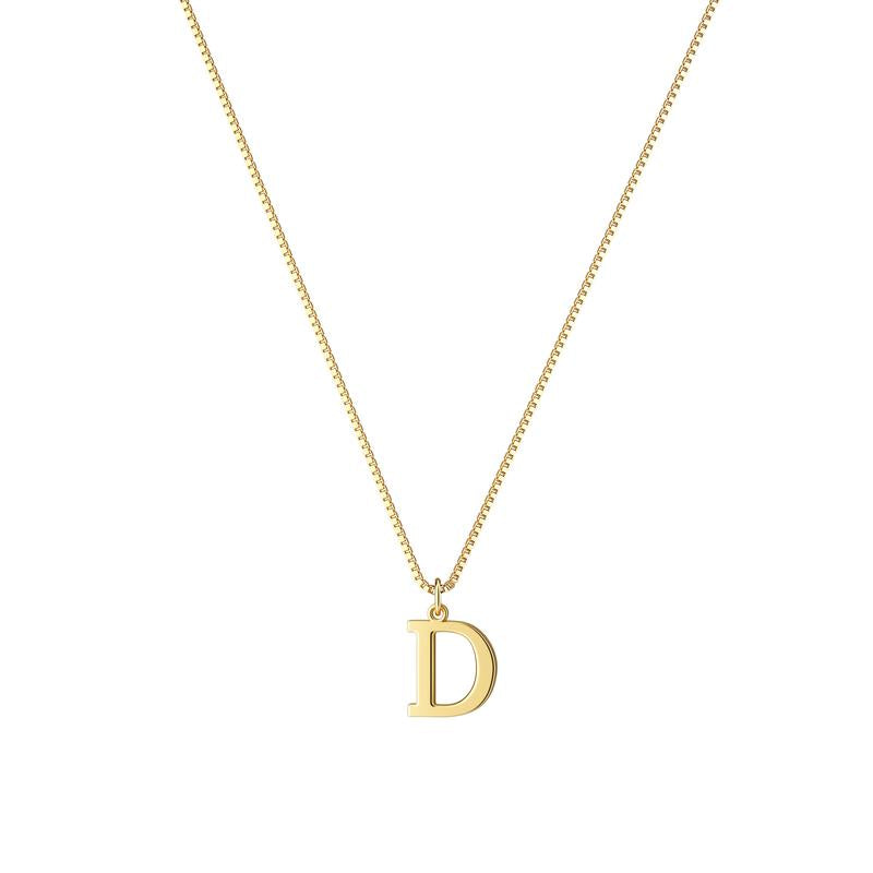 Close-up of a gold plated initial pendant on a women's necklace