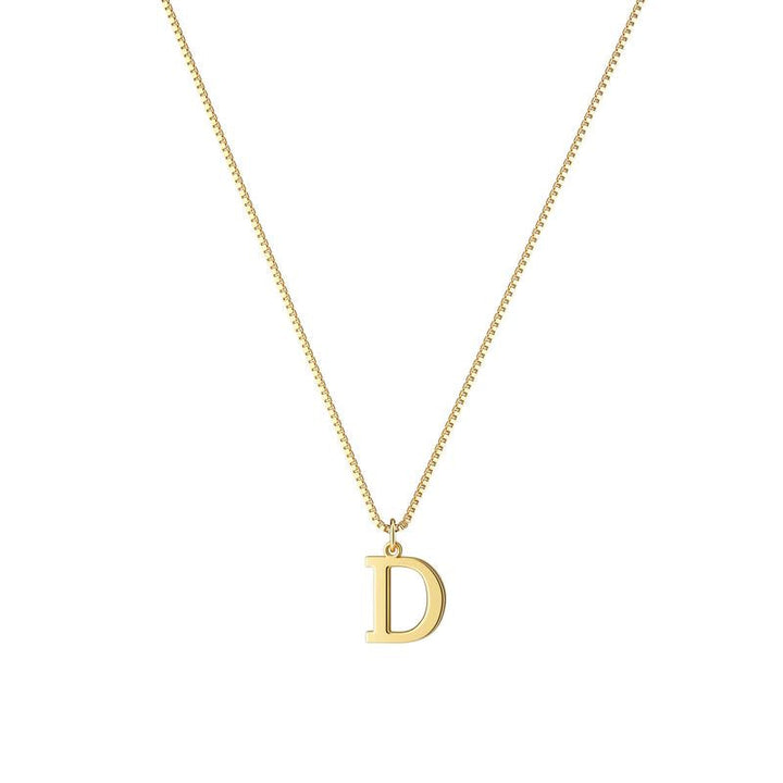 Close-up of a gold plated initial pendant on a women's necklace