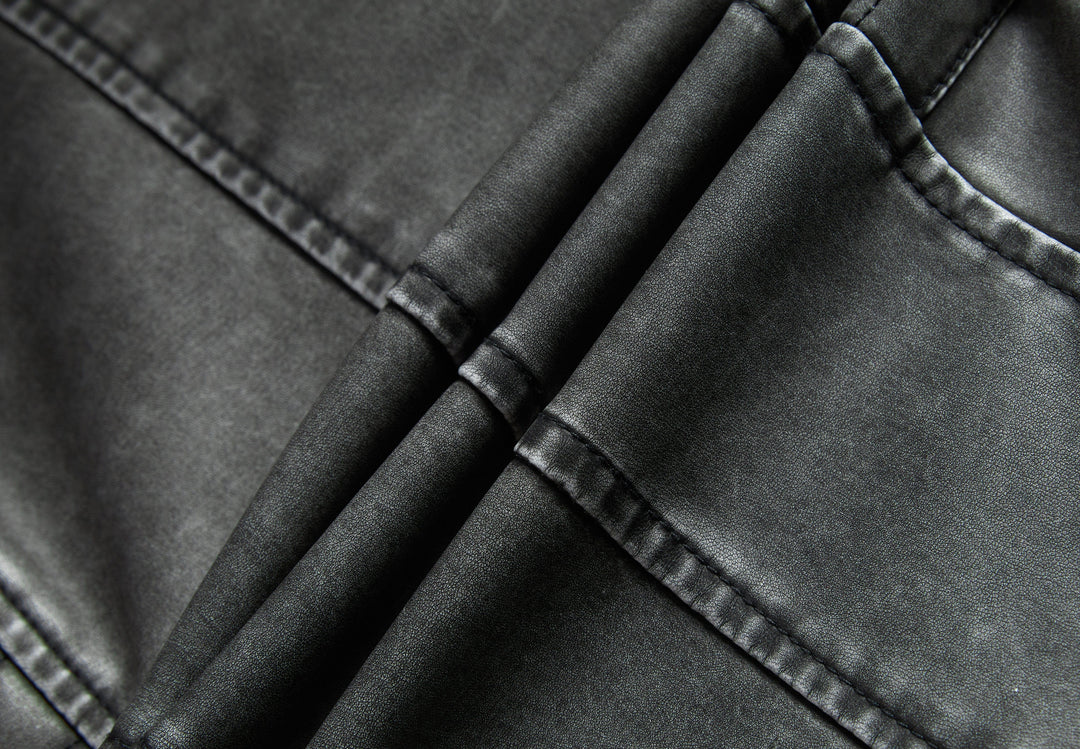 Detail of the collar and zipper on a women's gray moto-style faux leather jacket, showcasing quality.