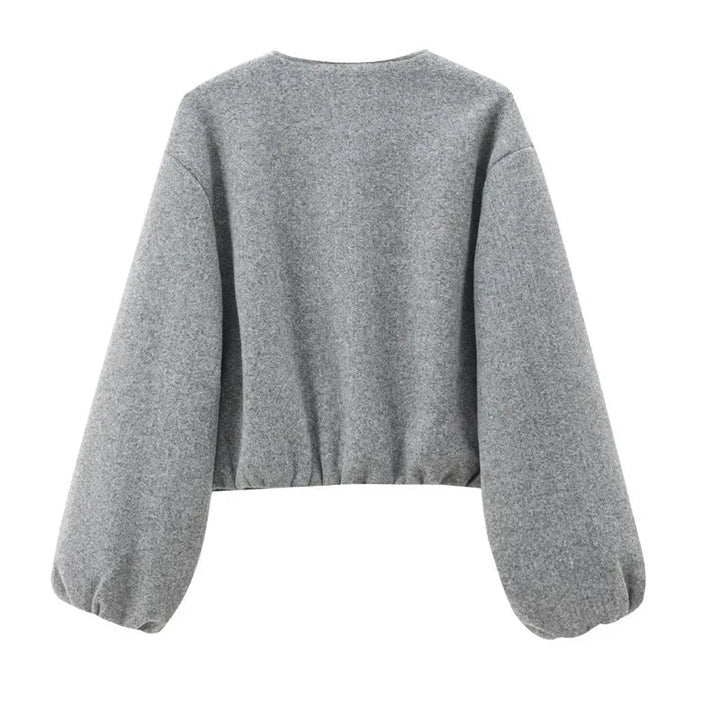 Stylish women's cropped zip-up sweater in grey, an ideal polyester top for casual autumn outfits.