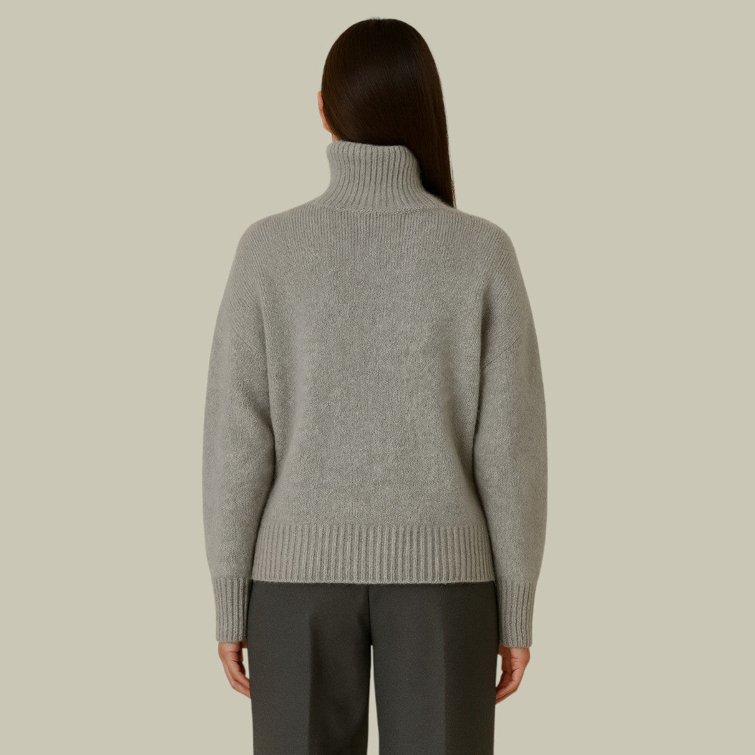 Close-up of a cozy women's high neck merino wool sweater, highlighting the knit and relaxed drape.