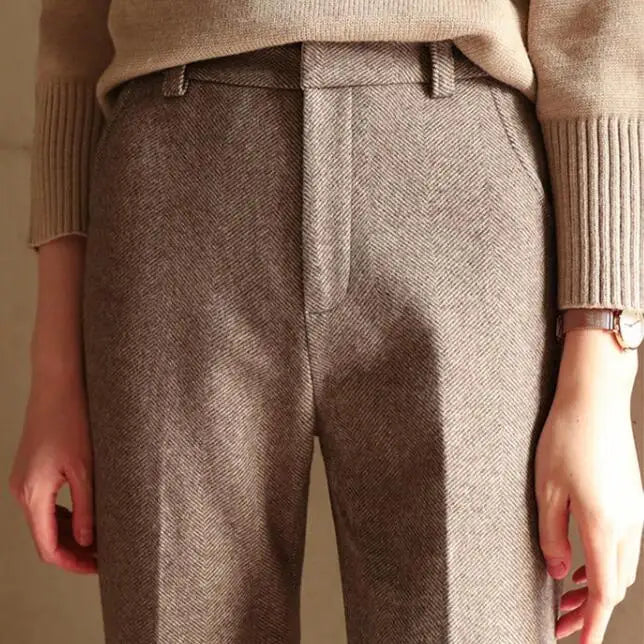 Front view of women wearing camel high-waist wool blend straight leg trousers with blouse