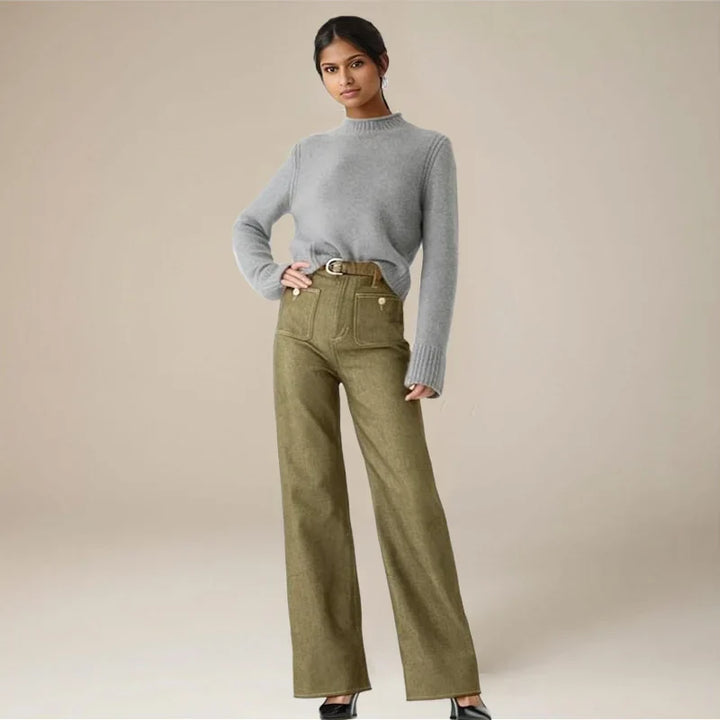 Detail shot of button and zipper on women's high-waist capri denim trousers, quality construction