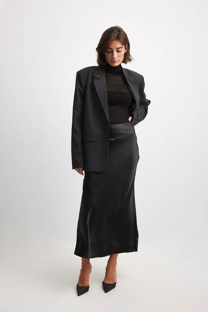 Women's high-waist satin midi skirt, flowing elegantly for a sophisticated look.