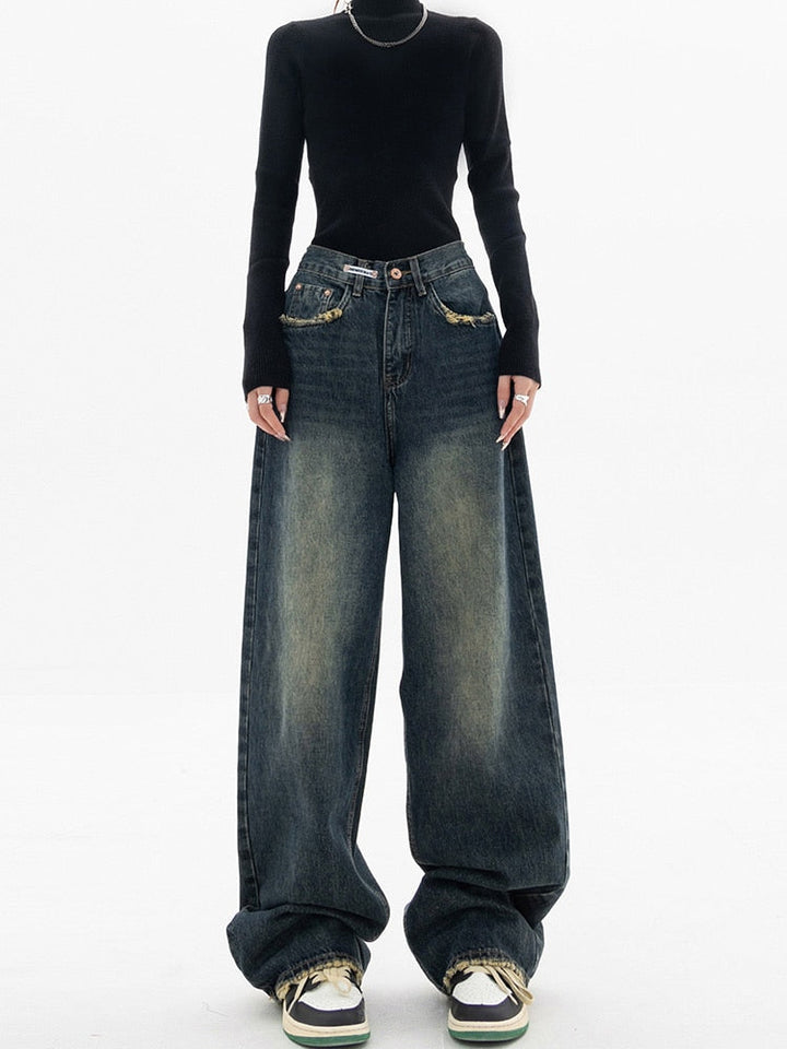 Stylish women's wide-leg denim jeans with a high waist and distressed details
